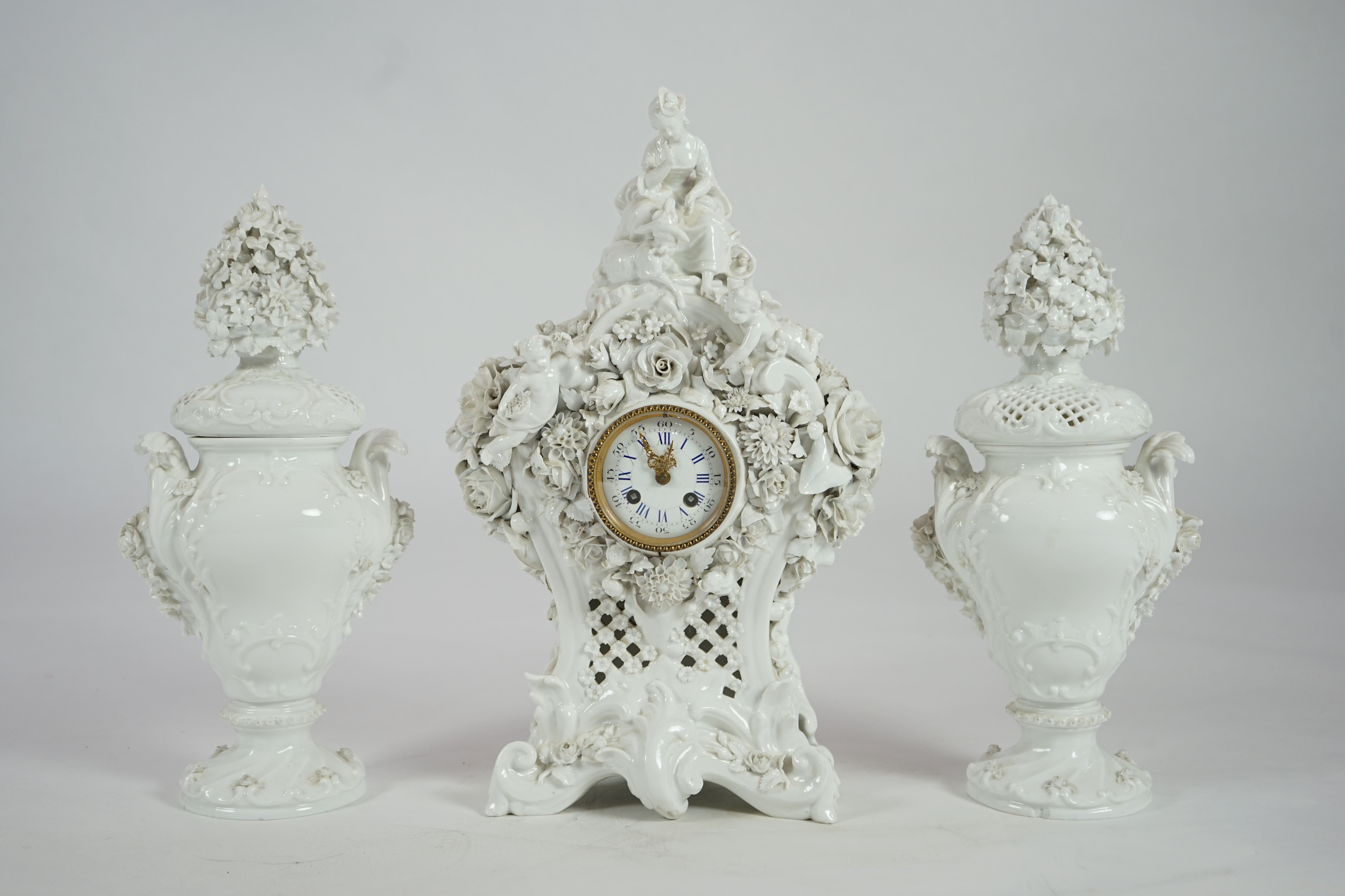 Vion & Baury. A 19th century Meissen style white glazed porcelain three piece clock set